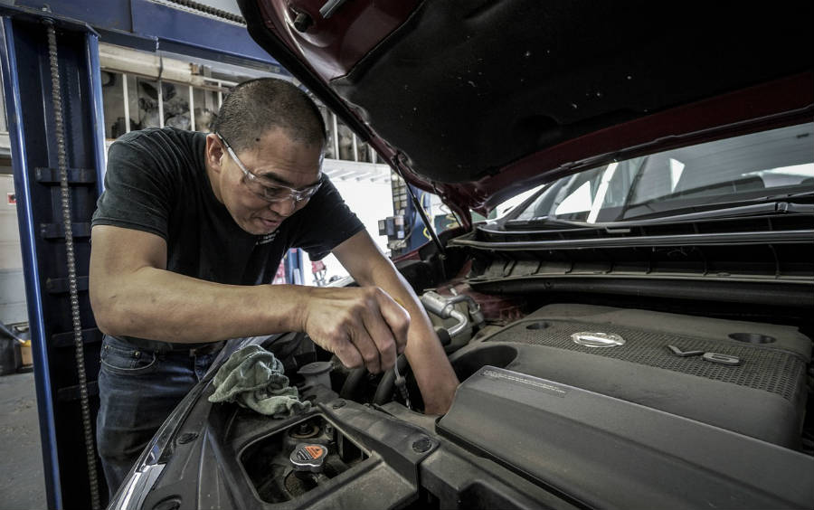 man repairing car