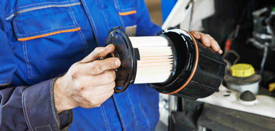 mechanic doing car service fuel filter changing